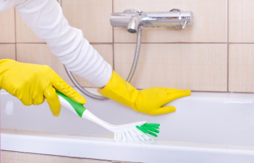 Professional cleaner treating a sofa in a Finchley property