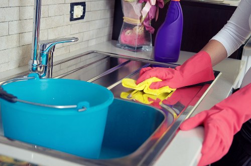 Professional office cleaner maintaining desks and floors in Finchley