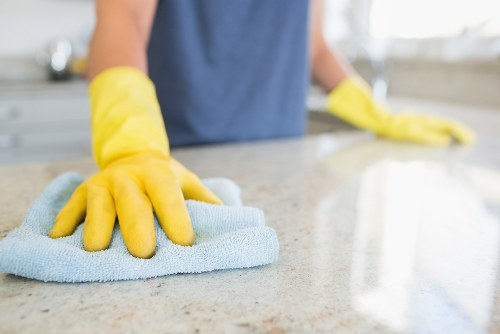 Staff member handling cleaning products with protective equipment