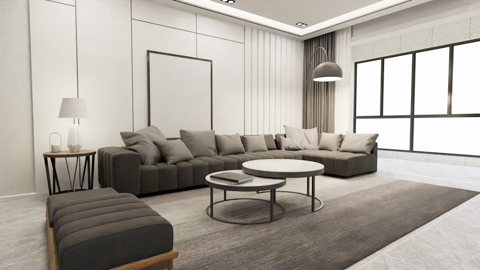 A spacious living room with large floor-to-ceiling windows providing a view of a cityscape, featuring a light grey L-shaped fabric sofa positioned on a dark grey rug. The room has white painted walls, and the hardwood floor is visible around the rug. Two white pendant lights hang from the ceiling, illuminating the room evenly. The windows are framed with light grey curtains, pulled back to let in natural light, highlighting the clean and tidy surface of the sofa and floor. No clutter or visual signs of dirt are visible, suggesting recent or ongoing surface cleaning and maintenance. The setting appears bright and freshly maintained, aligned with professional domestic cleaning standards by Finchley Carpet Cleaners.